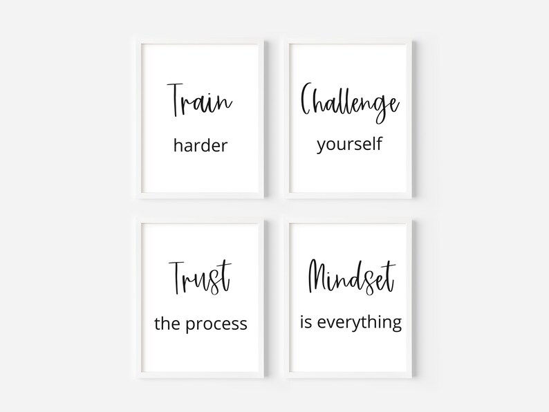 May include: Four white framed prints with black text on a white background. The prints read "Train harder", "Challenge yourself", "Trust the process", and "Mindset is everything".