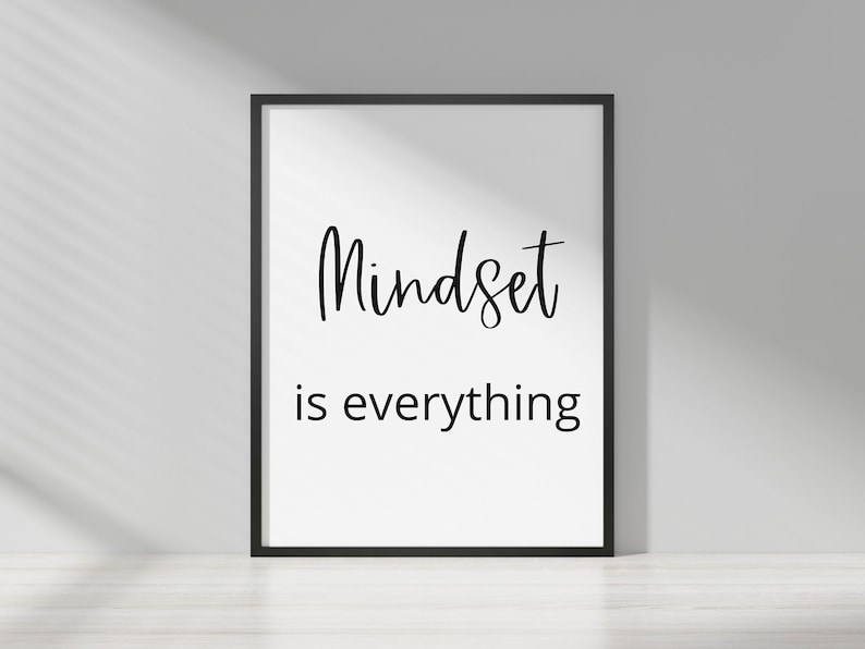 May include: A black framed print with white background and black text that reads "Mindset is everything".