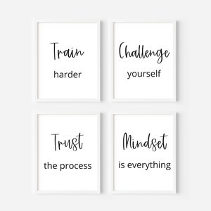 May include: Four white framed prints with black text on a white background. The prints read "Train harder", "Challenge yourself", "Trust the process", and "Mindset is everything".