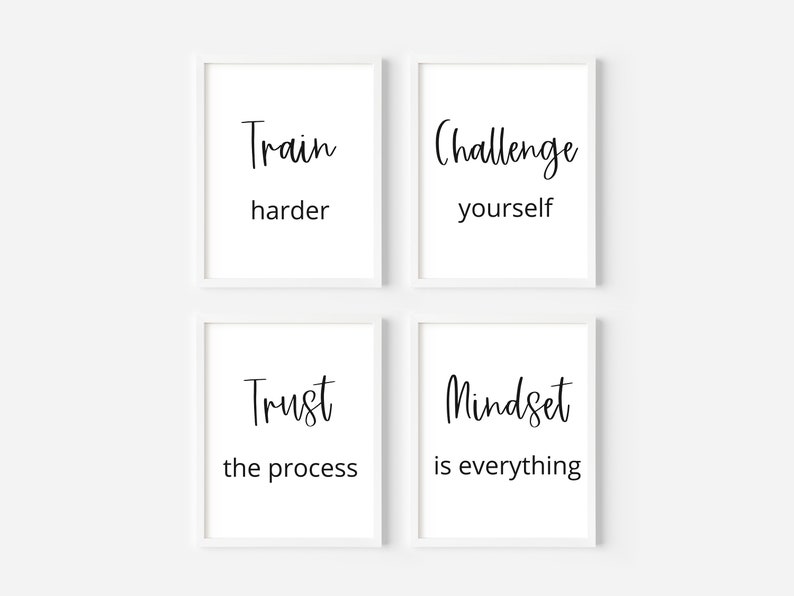 May include: Four white framed prints with black text on a white background. The prints read "Train harder", "Challenge yourself", "Trust the process", and "Mindset is everything".