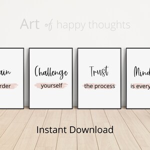 May include: Four printable wall art prints with motivational quotes. The quotes are "Train harder", "Challenge yourself", "Trust the process", and "Mindset is everything". Each quote is printed in black text on a white background with a pink brushstroke underneath.