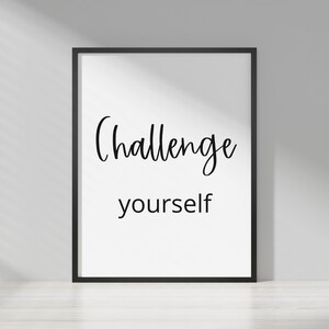 May include: Black and white framed print with the text "Challenge yourself" in a cursive font.