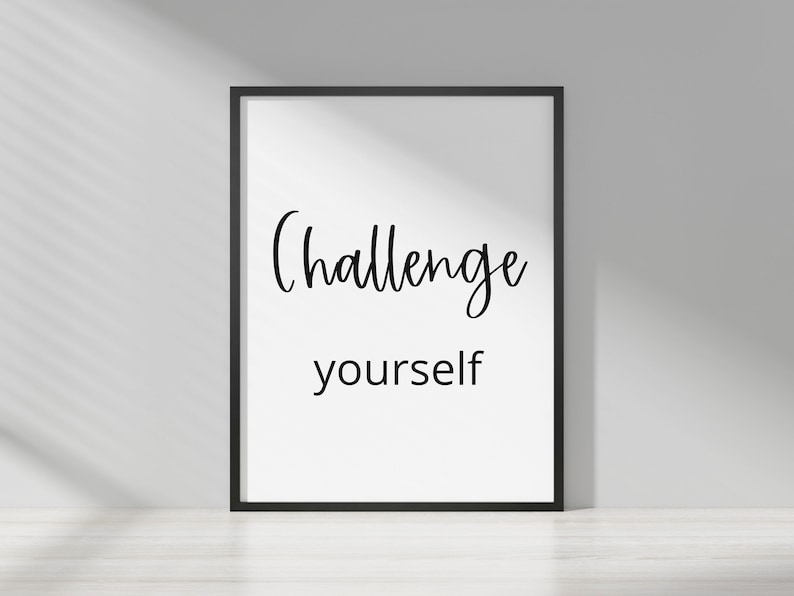 May include: Black and white framed print with the text "Challenge yourself" in a cursive font.
