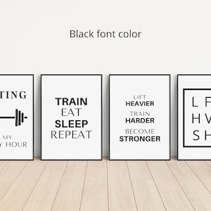 May include: Four framed motivational posters with black text on a white background. The posters feature phrases like "Lifting is my happy hour" and "Train Eat Sleep Repeat". The text "Black font color" is above the posters.