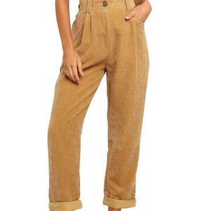 May include: Mustard-coloured corduroy trousers with a high waist, button fastening, and front pockets. The trousers have a relaxed fit and are cuffed at the ankles. The corduroy fabric has a vertical ribbed texture.