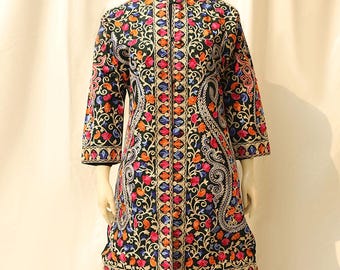 May include: A black long-sleeved jacket with a mandarin collar and intricate floral embroidery in shades of blue, pink, orange, and gold on a dark green background.