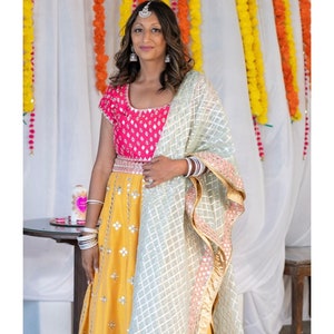 Yellow indian wedding lehenga with contrast pink blouse with mint green Chanderi dupatta