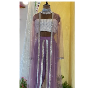 Lilac flowy crepe bridesmaids dhoti pants, sequins embroidered blouse paired with net pearl and sequins embroidery cape jacket indo western