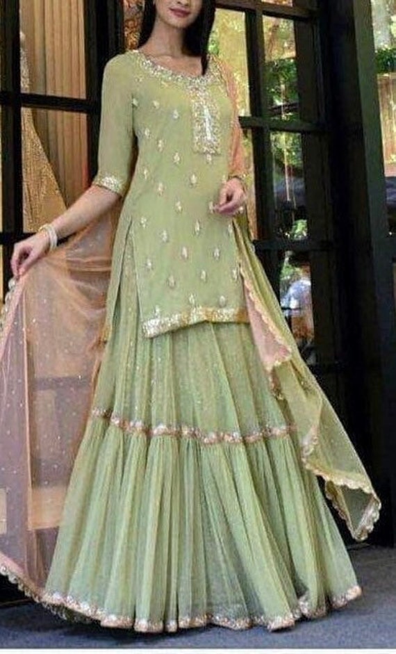 Pista green embroidered kurta with flared georgette mehendi lehenga and  contrast peach embroidery dupatta.