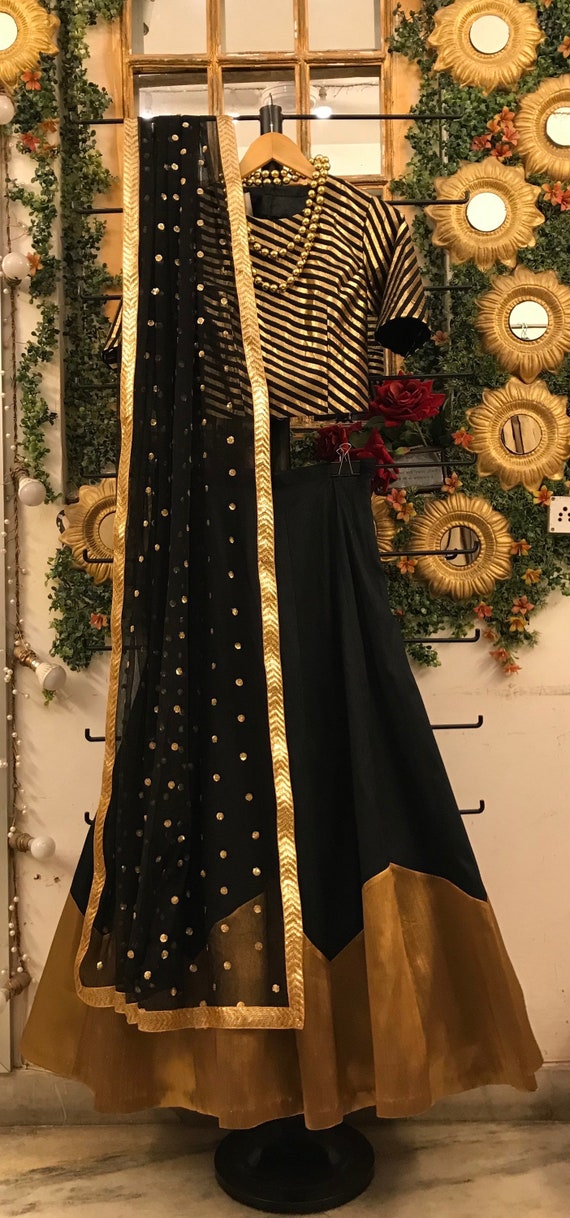 Black silk bridesmaid wedding lehenga skirt with golden zari border and  geometric pattern black gold crop top blouse and black net Dupatta