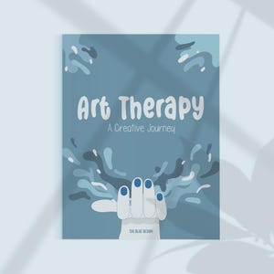 May include: A blue book cover with the title "Art Therapy" in white, with the subtitle "A Creative Journey." A hand with blue fingernails is reaching up, with blue and white abstract shapes. The text "THE BLUE DESIGN" is at the bottom.