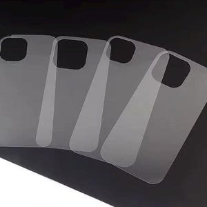 May include: Four clear plastic screen protectors for a smartphone. The protectors are stacked on top of each other.