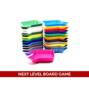 May include: A stack of colorful plastic trays in various shades of blue, green, yellow, red, and purple. The trays are shaped like a speech bubble and are stacked on top of each other. The trays are made of a durable plastic and are perfect for organizing small items.