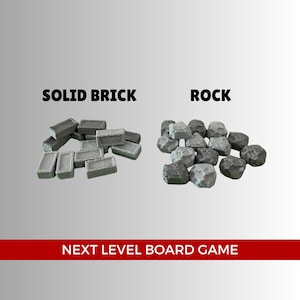 May include: Two piles of grey miniature building materials. The pile on the left is labelled "SOLID BRICK" and contains small rectangular bricks. The pile on the right is labelled "ROCK" and contains small, irregularly shaped rocks.