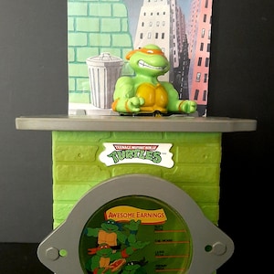 アメコミ Teenage Mutant Ninja Turtles coin bank Amazon.com: Teenage Mutant Ninja Turtles Coin Bank Bundle
