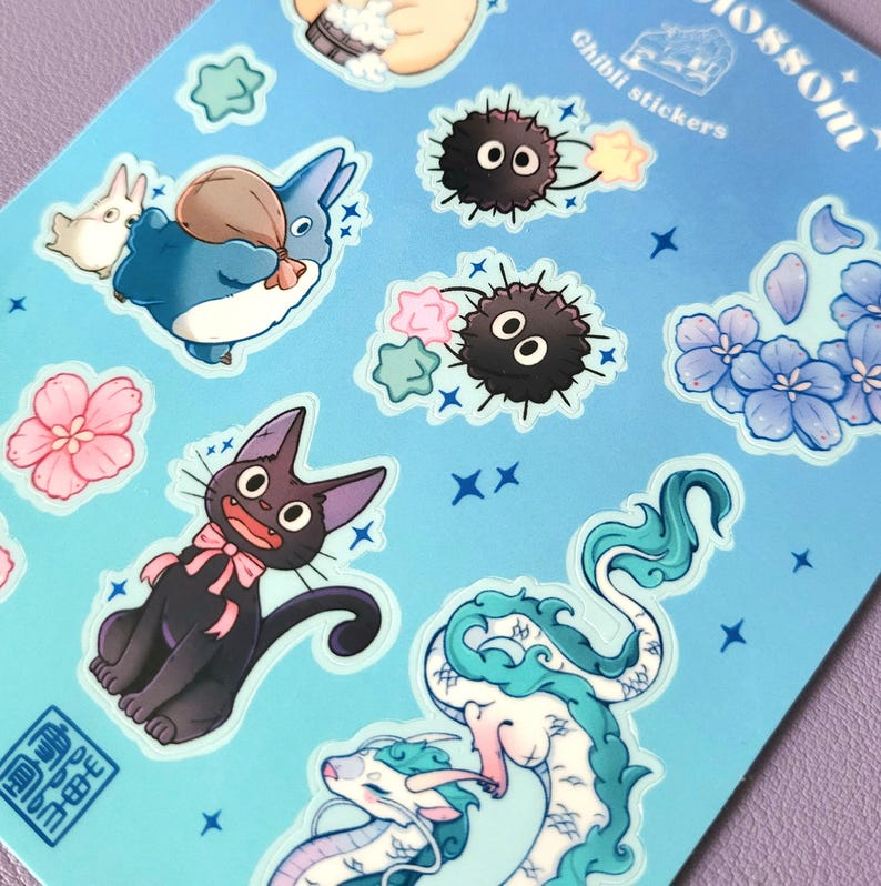 May include: A sheet of blue stickers featuring characters from Studio Ghibli films. The stickers include Totoro, No Face, Jiji the cat, and the dragons from Spirited Away. The stickers are surrounded by stars and flowers.