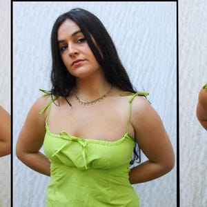 May include: A woman wearing a lime green spaghetti strap dress with a bow at the neckline. She is smiling and looking at the camera.