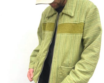 May include: A green and yellow striped jacket with a brown felt patch and a zipper closure. The jacket has a kangaroo logo on the front with the word "Australia" underneath.