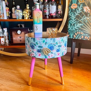 Round small coffee table with drawer. Ideal for nightstand, end table or side table. Pink and mint green flamingo design with gold top