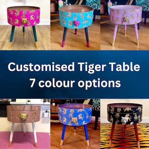 May include: Seven different colour options for a customised tiger table. The table is round with a drawer and gold legs. The table is decorated with a tiger print and a gold tiger head handle.