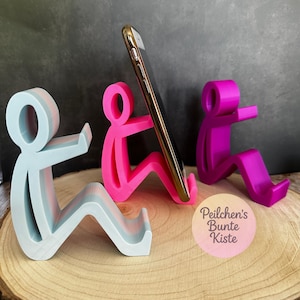 Humorvolle Smartphone-Halterung – sitzende Figur als Handy-Ständer, witziges Geschenk/ Büro- & Schreibtisch-Deko in vielen Farben erhältlich