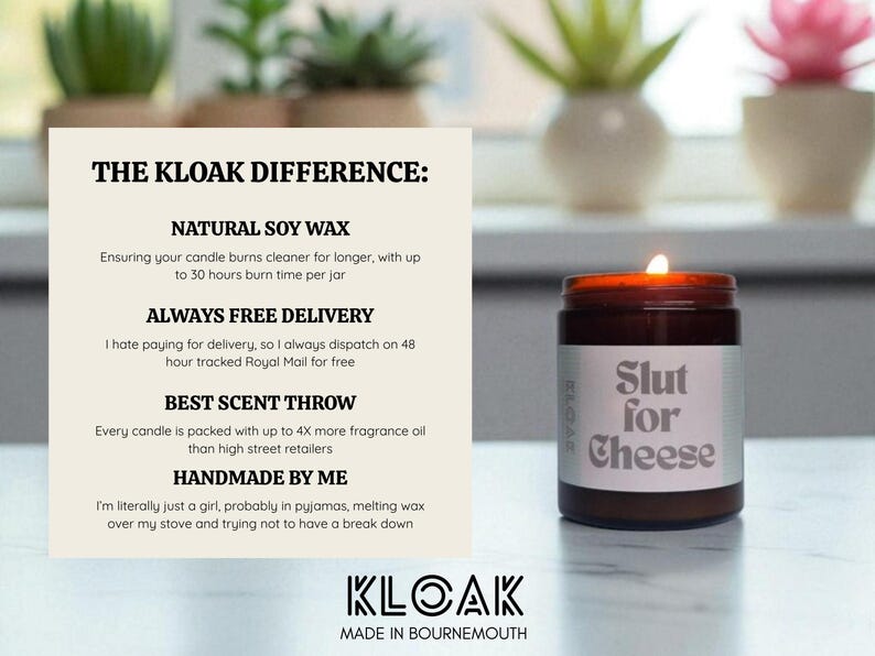 May include: A lit, brown glass jar candle with a white label that reads "Slut for Cheese." The candle is part of the KLOAK brand, which is handmade with natural soy wax and offers free delivery.