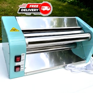 May include: A light blue electric dough roller machine with two horizontal stainless steel rollers. The side panel features two red power switches labeled ON, OFF, and SPEED ON1, OFF, ON2. A yellow caution triangle icon is visible on the side.