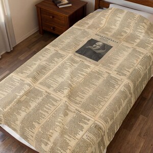 May include: A beige bedspread featuring a repeating vintage print of Shakespearean text and a central black and white portrait of William Shakespeare. The fabric displays columns of printed script with the title SHAKESPEARES and the word EPILOGUE visible.