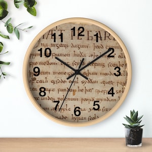 May include: A round clock with a wood frame and a white face. The clock face features black Roman numerals and black hands. The background of the clock face is a vintage-looking parchment with black text.