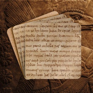 May include: A stack of aged, square-cornered paper cards with handwritten text in a faded brown ink. The cards are layered against a textured, brown background with carved relief details, suggesting an ancient theme.