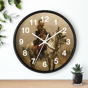 May include: A round wall clock with a black frame featuring a printed image of a soldier in a historical military uniform riding a white horse. The clock face displays large white Arabic numerals from 1 to 12 and white hour, minute, and second hands.