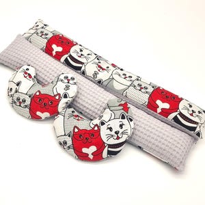 Könnte beinhalten: Ein Set aus drei grauen und weißen Kissen mit Katzenmotiv. Die Kissen sind aus weichem Stoff gefertigt und haben eine Waffelstruktur. Die Kissen sind perfekt, um jedem Raum eine Prise Verspieltheit zu verleihen.