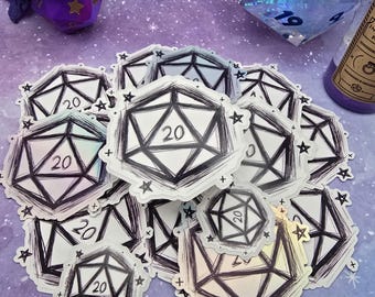 May include: A close-up of a pile of iridescent holographic stickers featuring a black and white illustration of a twenty-sided die. The stickers have a white background and black lines outlining the die. The die has a star on each face and the number "20" in the centre.
