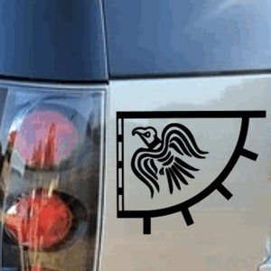 May include: Black and white vinyl sticker of a stylized raven on a banner. The raven is facing right and has its wings spread. The banner has a curved edge and a series of spikes along the bottom.