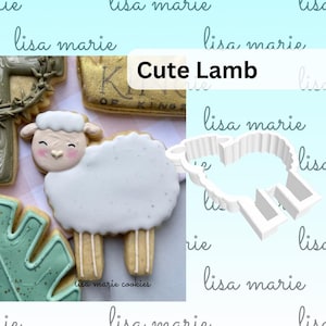 May include: A white cookie shaped like a lamb with a pink face and black eyes. The cookie is next to a white plastic cookie cutter shaped like a lamb. The text "Cute Lamb" is written in black on a yellow background.