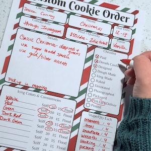 May include: A custom Christmas cookie order form with red and green accents. The form includes details for cookie flavors, icing colors, and shapes. The order is for Jessica Conroy, with a pickup date of December 12-13.