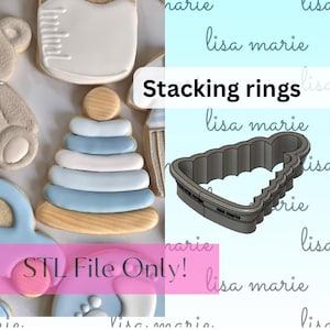 May include: A 3D printed cookie cutter in the shape of a stacking ring toy. The cutter is made of gray plastic and has a smooth, rounded surface. The text "STL File Only!" is visible in pink letters on the image.