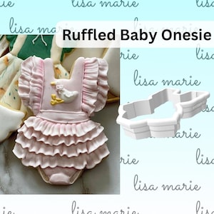 May include: A pink cookie decorated to look like a baby onesie with a ruffle trim and a small duck design. A white plastic cookie cutter in the shape of a baby onesie is also shown. The text "Ruffled Baby Onesie" is written in white letters on a pink background.
