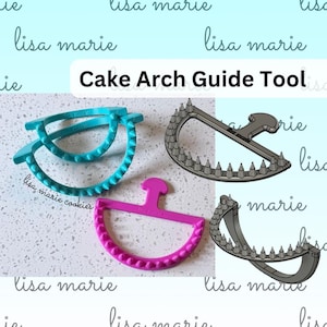 May include: A set of Cake Arch Guide Tools in teal, pink, and grey. These semi-circular tools feature a handle and a row of pointed spikes along the curved edge. The text "lisa marie" is embossed on the tools, and the image includes the text "Cake Arch Guide Tool".
