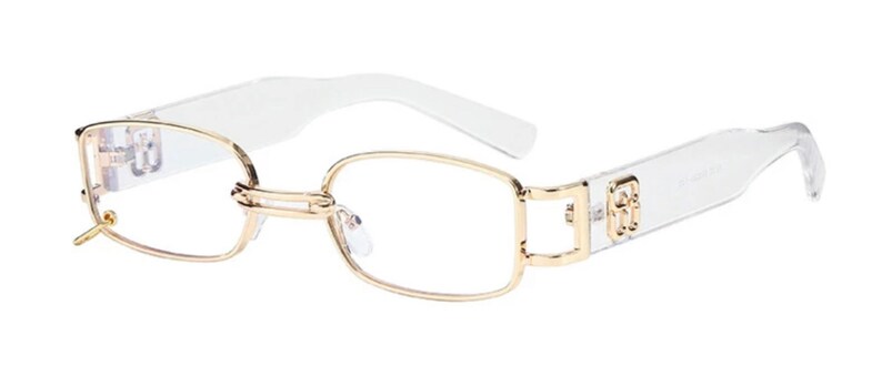 May include: Clear frame glasses with gold metal accents. The glasses have a rectangular shape and a clear plastic frame.