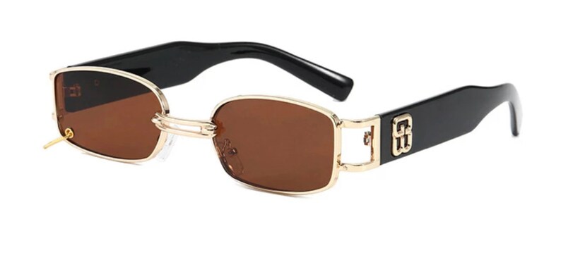 May include: Gold-rimmed sunglasses with brown lenses and black frames. The frames have a gold logo on the side.