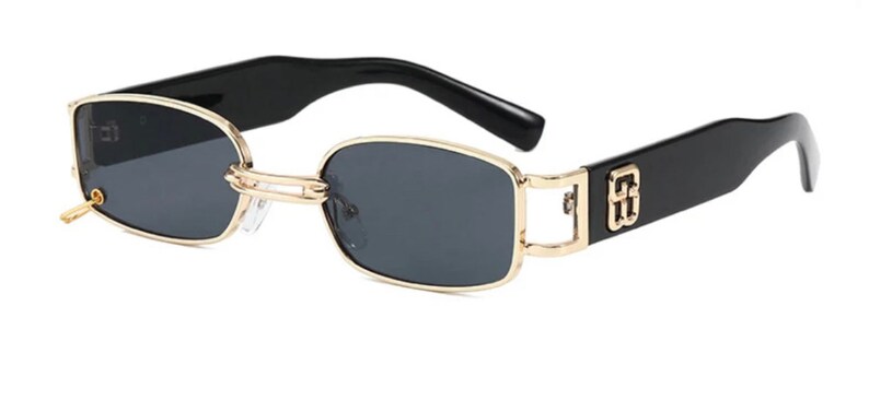 May include: Black rectangular sunglasses with gold metal frames and black arms. The arms have a gold logo.