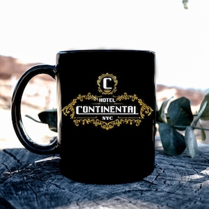 May include: Black ceramic mug with a gold logo that reads "Hotel Continental NYC".