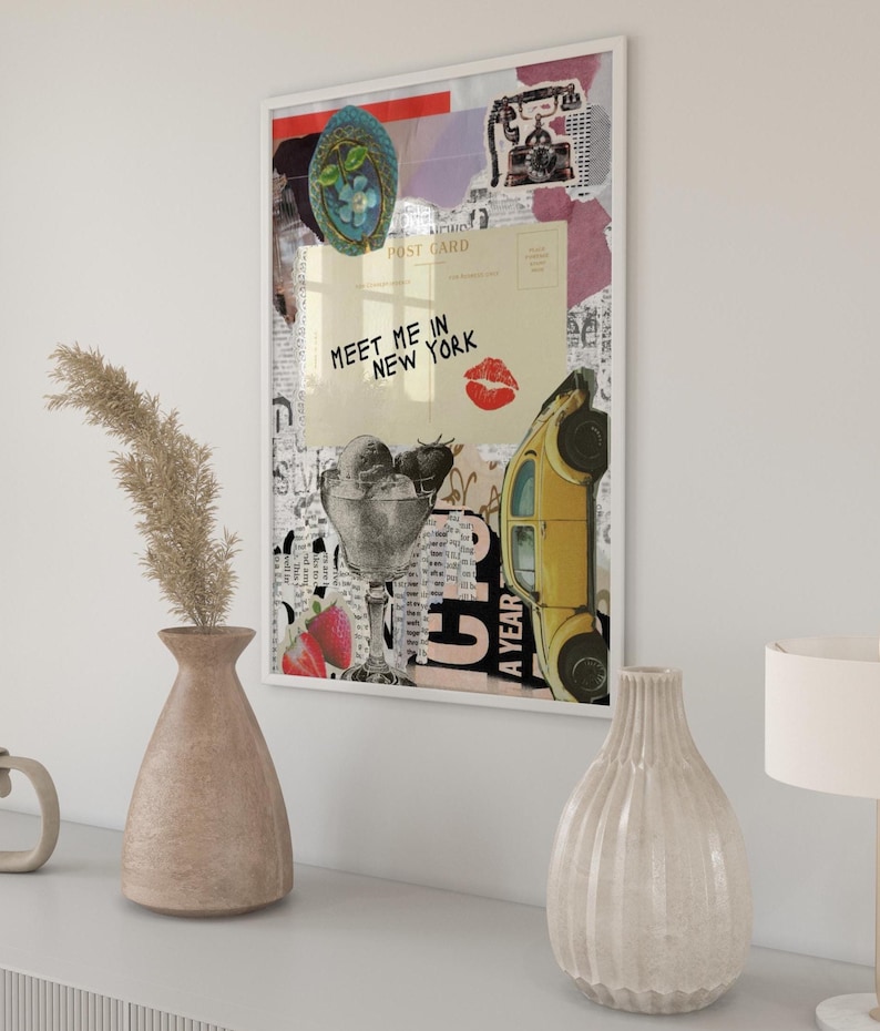 May include: A framed collage art print featuring vintage imagery. The artwork includes a yellow car, ice cream, a postcard with the text "Meet Me in New York," and a red kiss mark. The print is displayed on a white wall.