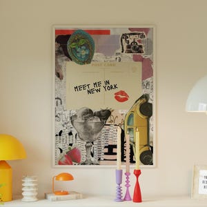 May include: A framed collage print featuring a vintage postcard with the text "Meet Me in New York" and a red lipstick kiss. The artwork includes images of ice cream, strawberries, and a yellow car.