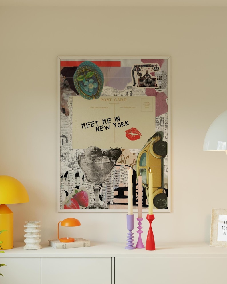 May include: A framed collage print featuring a vintage postcard with the text "Meet Me in New York" and a red lipstick kiss. The artwork includes images of ice cream, strawberries, and a yellow car.