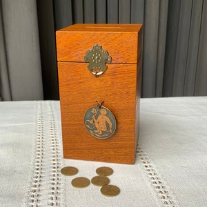 Wooden piggy bank, cash box, with brass decor and devil sign, Funny Devil.