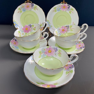 One duo, RARE vintage 1930s hand-painted Victoria C&E, bone china teacup and saucer from England, featuring a green floral design.