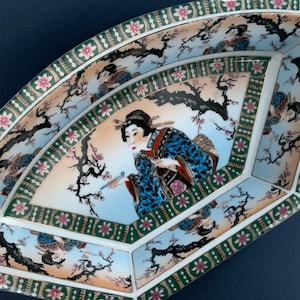 Gold trim Chinese-style vintage plate bowl is a uniquely shaped decorative dish.