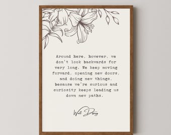 May include: A framed print with a quote by Walt Disney. The quote reads: "Around here, however, we don't look backwards for very long. We keep moving forward, opening new doors, and doing new things, because we're curious and curiosity keeps leading us down new paths."